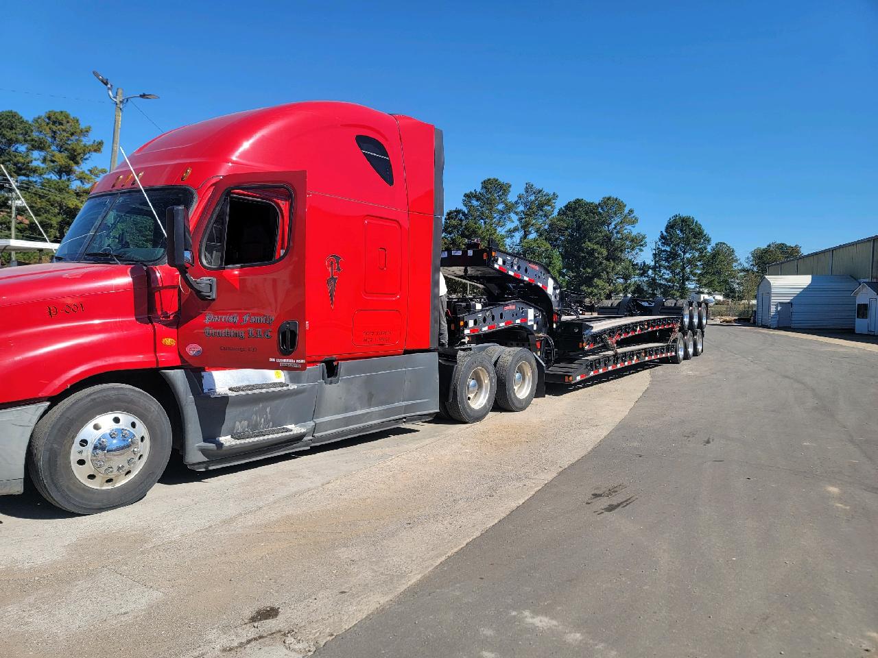 Step deck trailer transporting tall industrial cargo for freight logistics